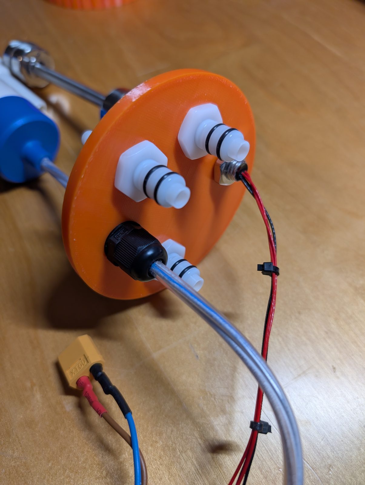 Lid, outside: four water couplings and a cable gland. The lid seen from the outside, with quick couplings and cable gland fitted